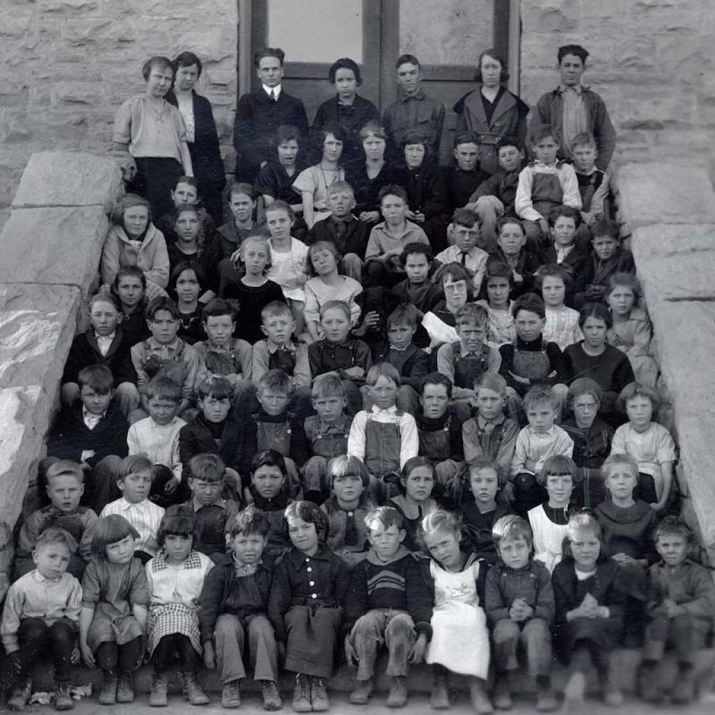 children on the steps of the school building